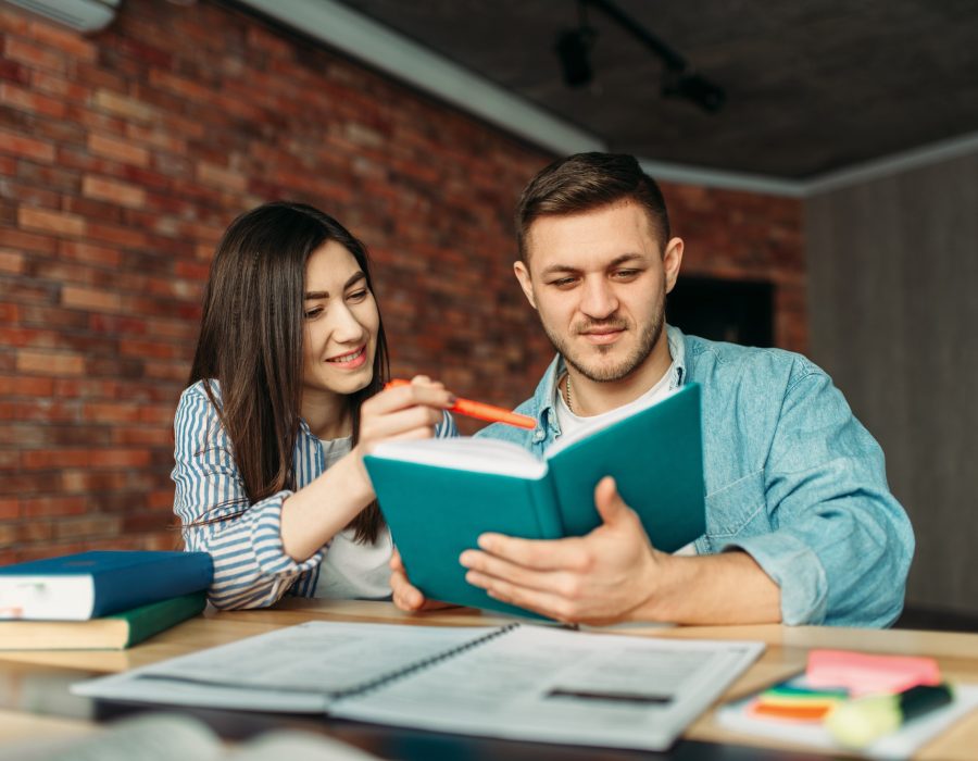 university-students-reading-textbook-together.jpg